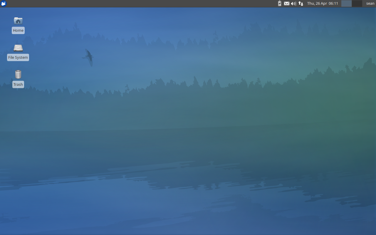 The Xubuntu 12.04 desktop features a minimalistic default environment. Shortcuts to Home, File System, and Trash are featured prominently.